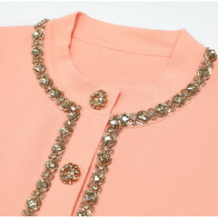 Close-up of pink knit top embellished neckline and buttons
