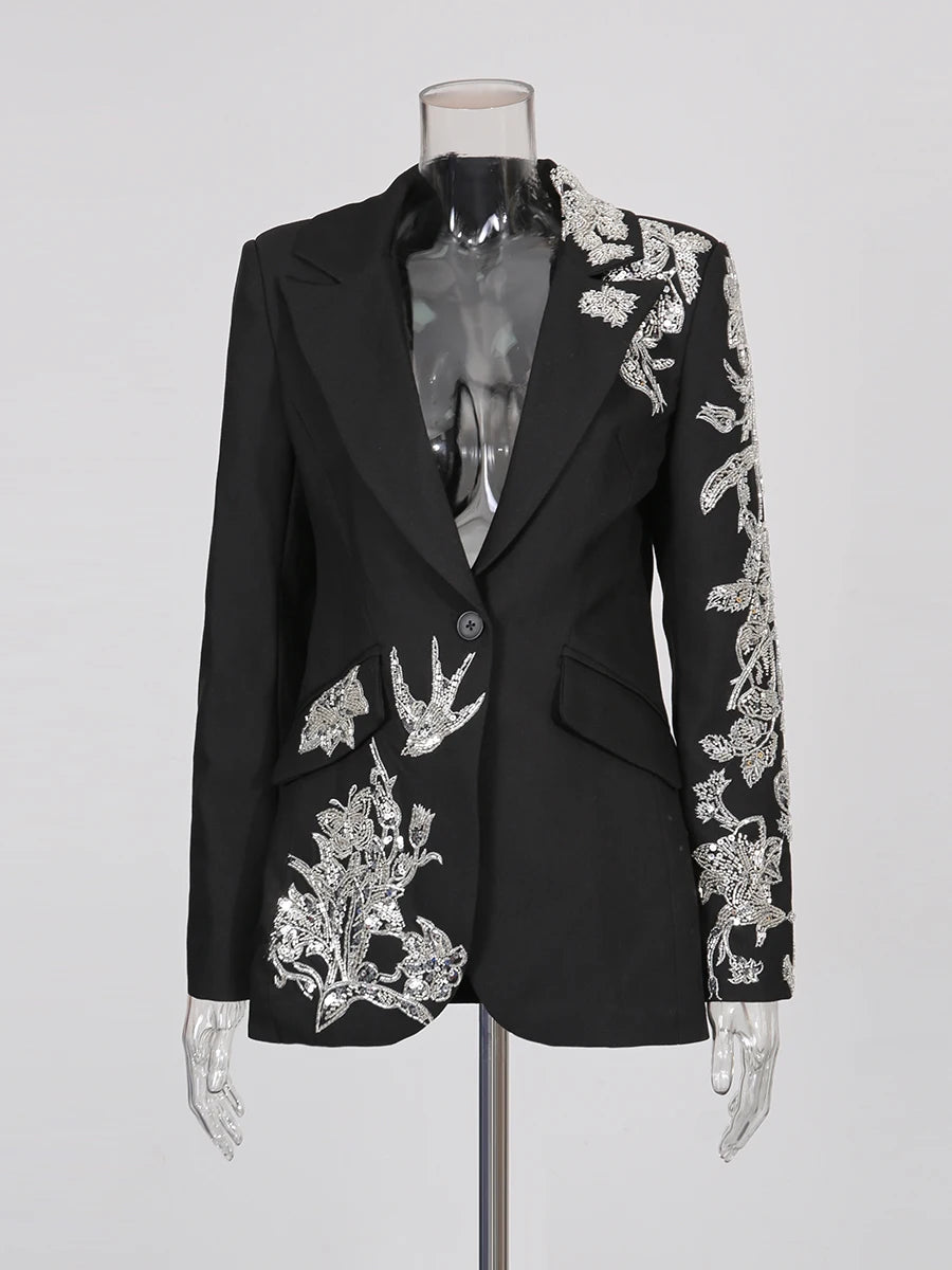 Black blazer with silver floral embroidery on a mannequin against a white background