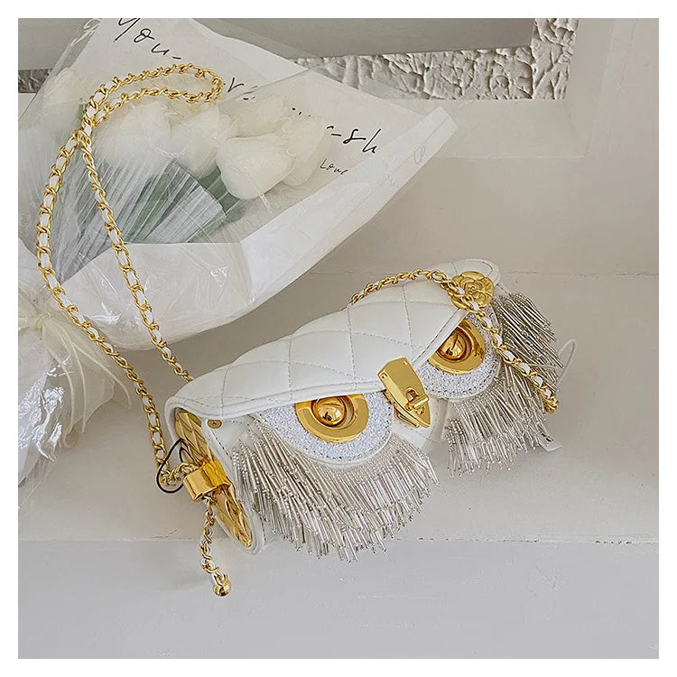 White quilted owl chain bag with fringe detail