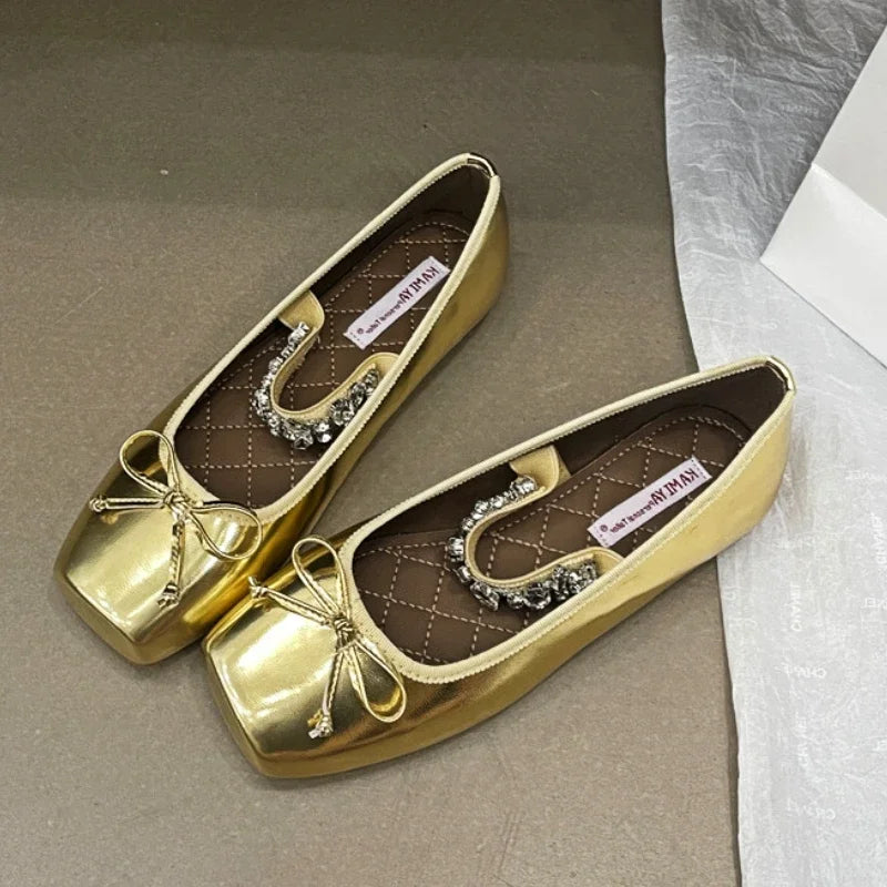 Gold square toe ballet flats with a bow and crystal embellishment