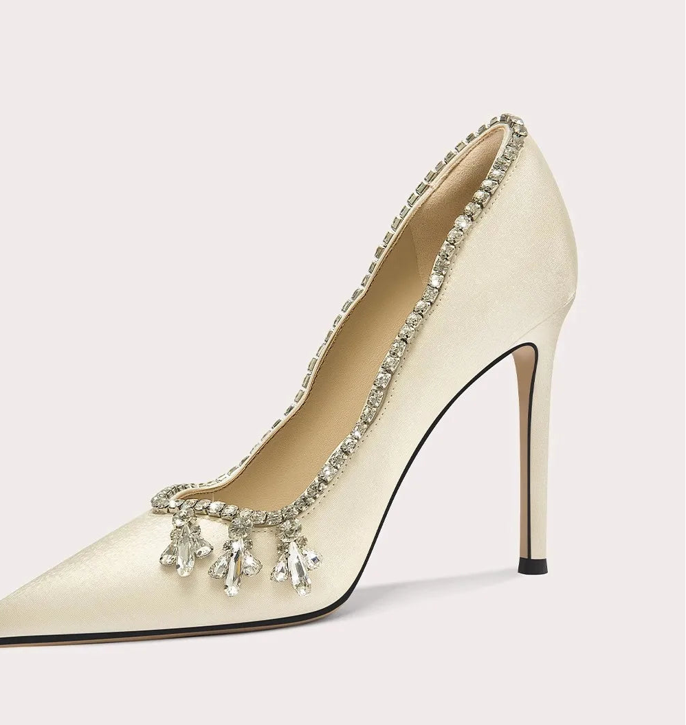 High-heeled shoe with decorative elements on a light gray background