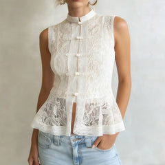White lace sleeveless top worn by a person on a plain background