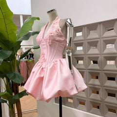 Side view of pink appliqued floral halter mini dress with corseted bodice
