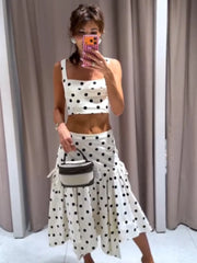 Person wearing a polka dot outfit with a white background