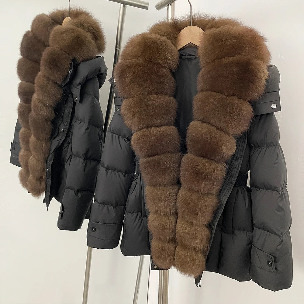 Black puffer jacket with brown fur collar on a hanger 