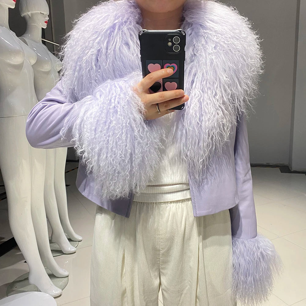 Person wearing a light purple fluffy jacket taking a mirror selfie.