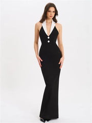 Woman wearing a black evening gown with white accents on a white background