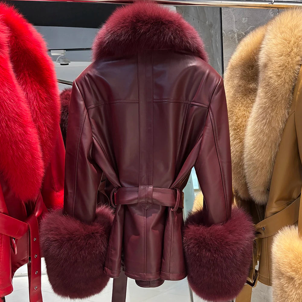 Burgundy leather coat with fur trim displayed in a store window.