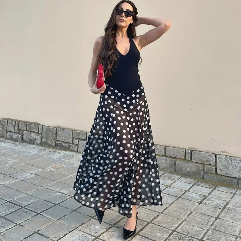 Close-up of a polka dot print halter neck maxi dress