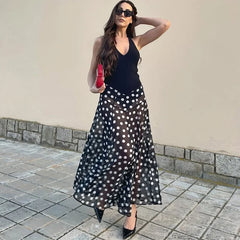 Close-up of a polka dot print halter neck maxi dress