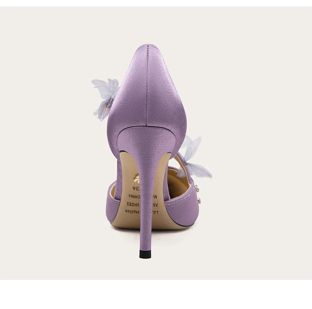 Purple high-heeled shoe with floral details on a white background