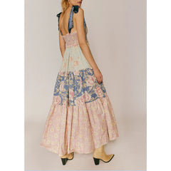 Woman wearing a floral dress with a plain background