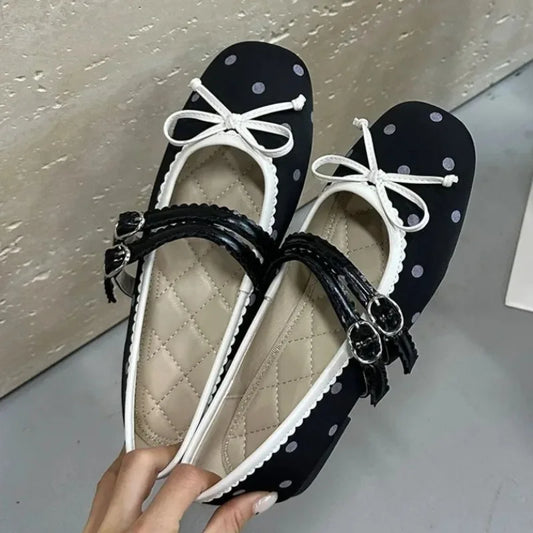 Black polka dot ballet flats with white trim and white bow