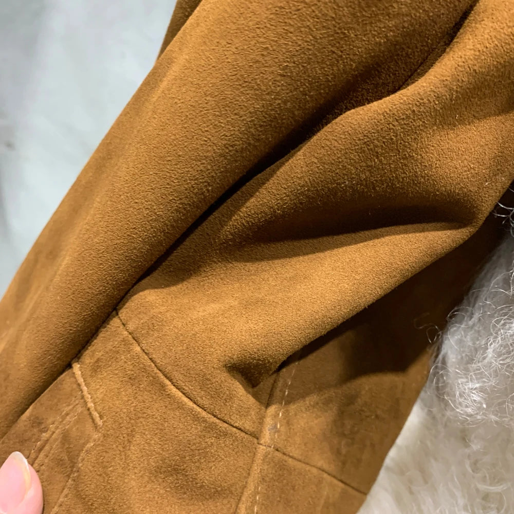 Close-up of brown fabric texture with a hand holding it