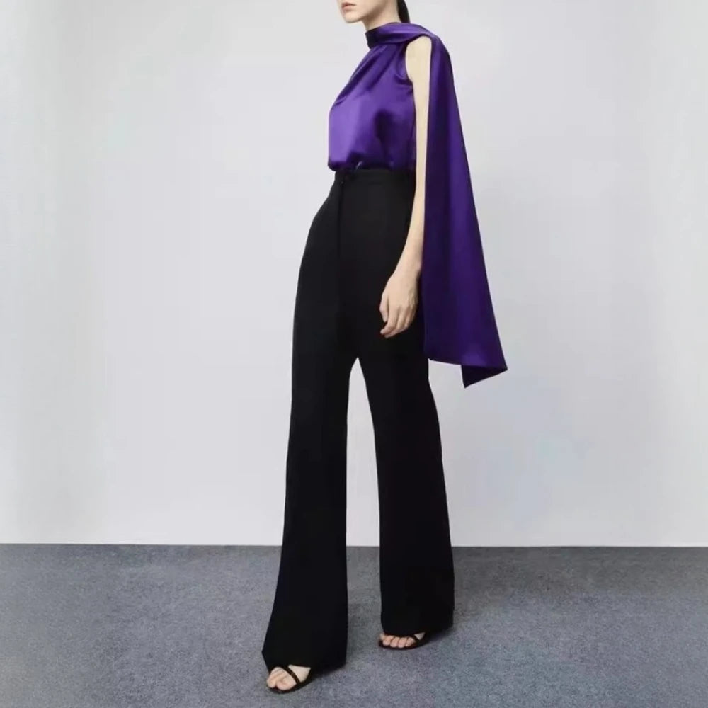 Person wearing a purple top and black pants 