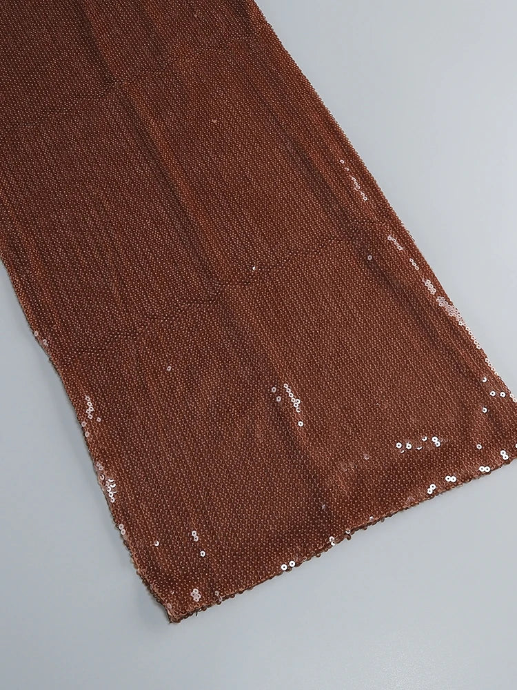Brown fabric with sequin embellishments on a light gray background