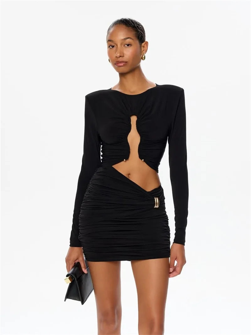 Woman wearing a black dress with cut-out design on a white background