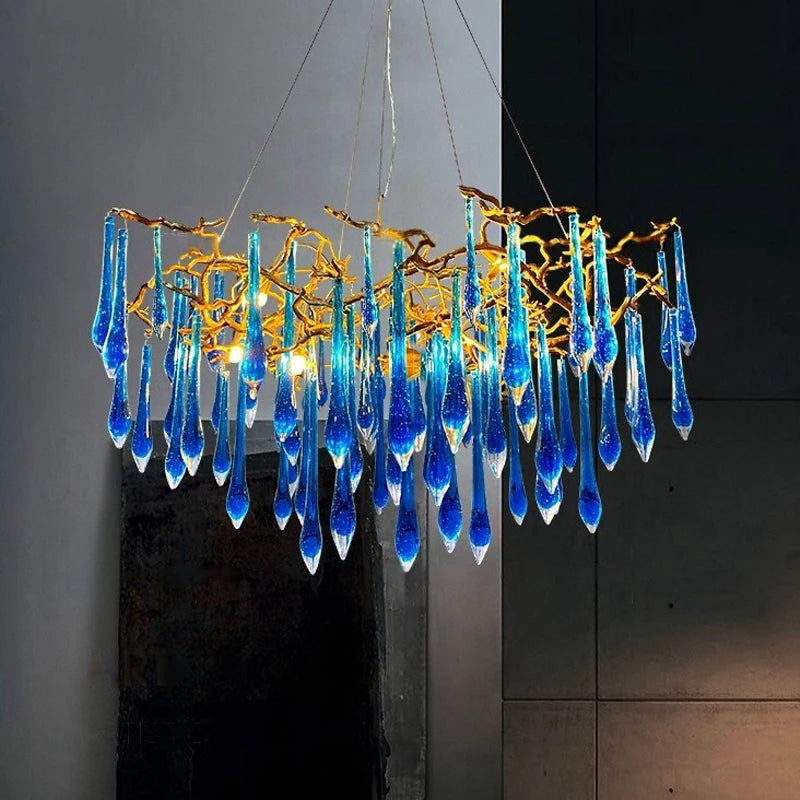 Blue glass chandelier with gold accents against a dark background