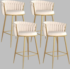 Four white bar stools with gold legs on a white background