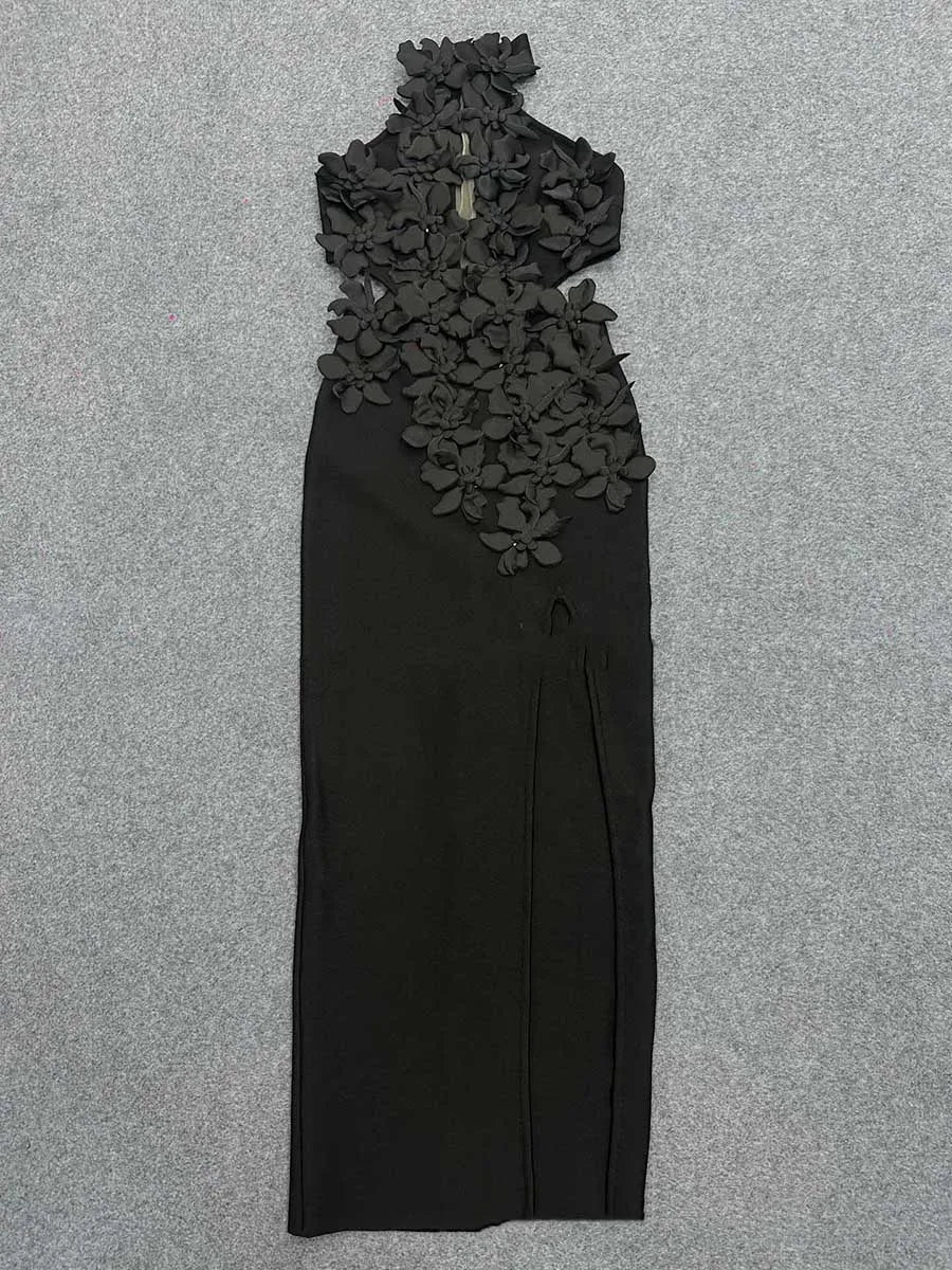 Black dress with floral lace details on a gray background