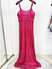 Pink evening gown with beaded details on a hanger against a white background