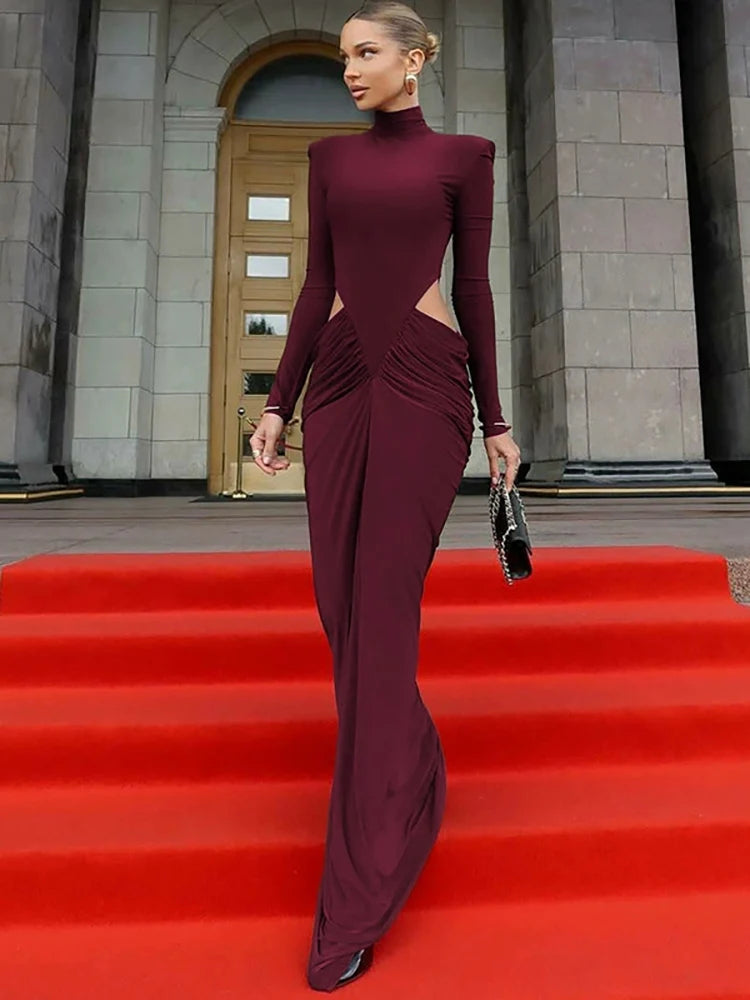 Woman in a burgundy evening gown on a red carpet