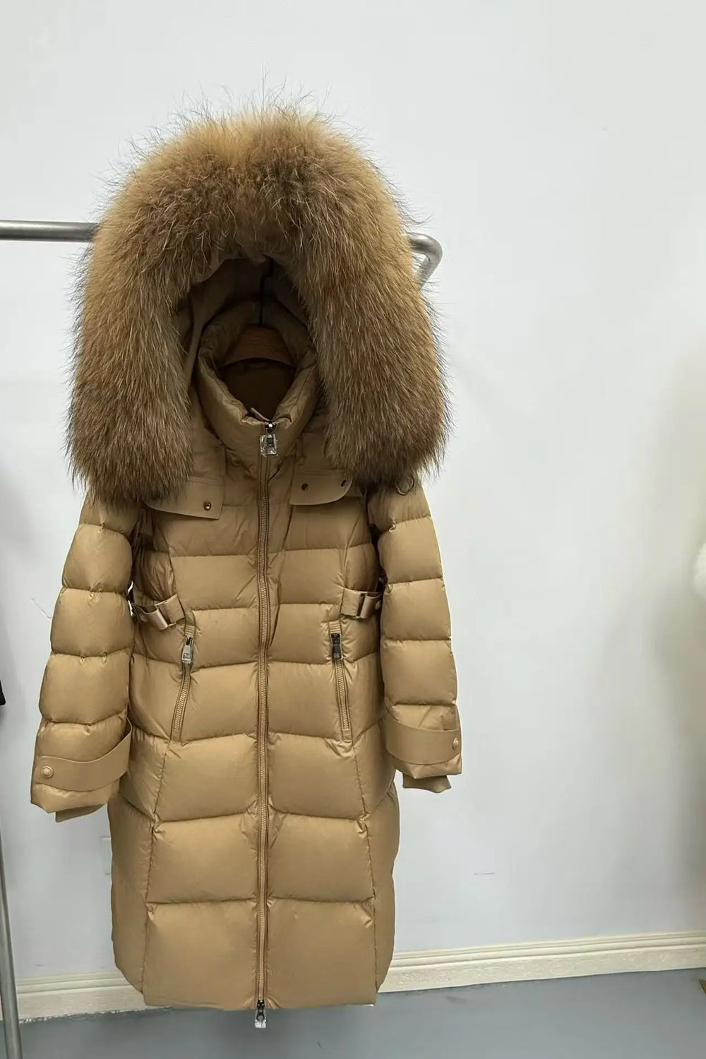 Beige puffer jacket with a large fur hood 
