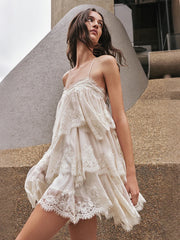 Beige lace trim halterneck mini dress in an urban setting