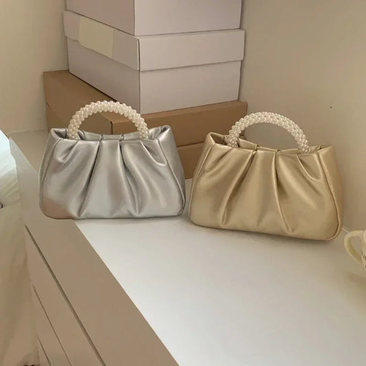 White gathered clutch bag with a pearl handle