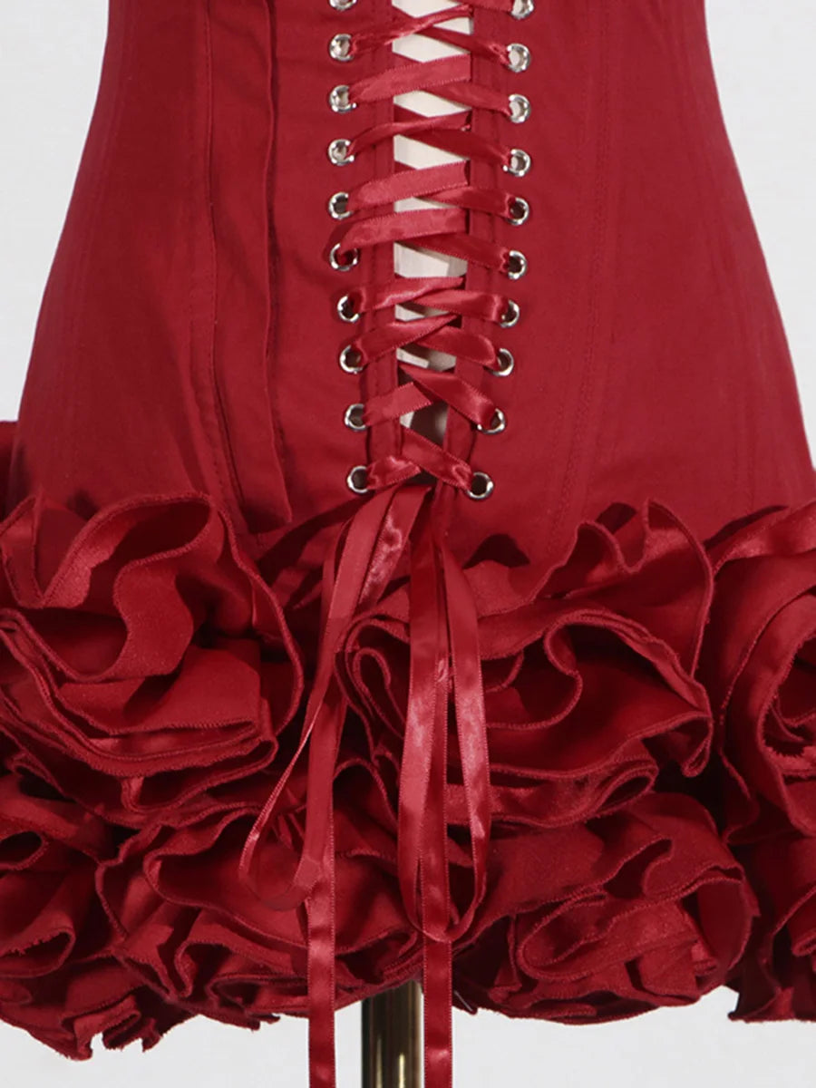 Red dress with ruffled skirt and corset-style lacing on a white background