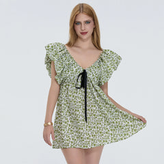 Woman wearing a green floral dress on a white background