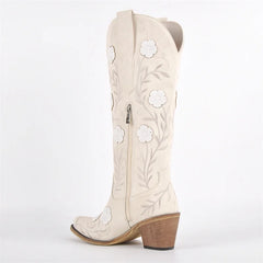 White cowboy boot with floral embroidery on a white background