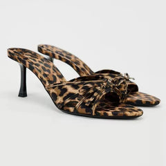  A pair of leopard print high heel mules with a bow knot detail, resting on a white background.. Golden Atelier 3