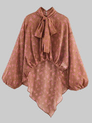 Brown floral blouse with a bow neckline on a white background