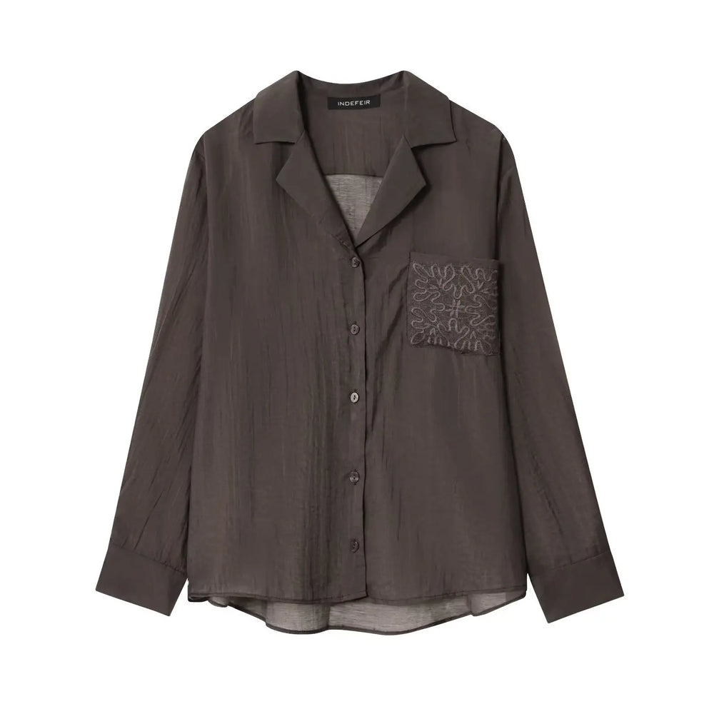 Brown shirt with a pocket design on a white background