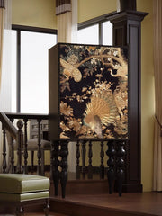 Decorative cabinet with peacock design in a room with a staircase and window.