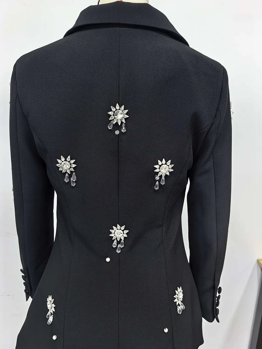 Black coat with decorative silver buttons on a white background
