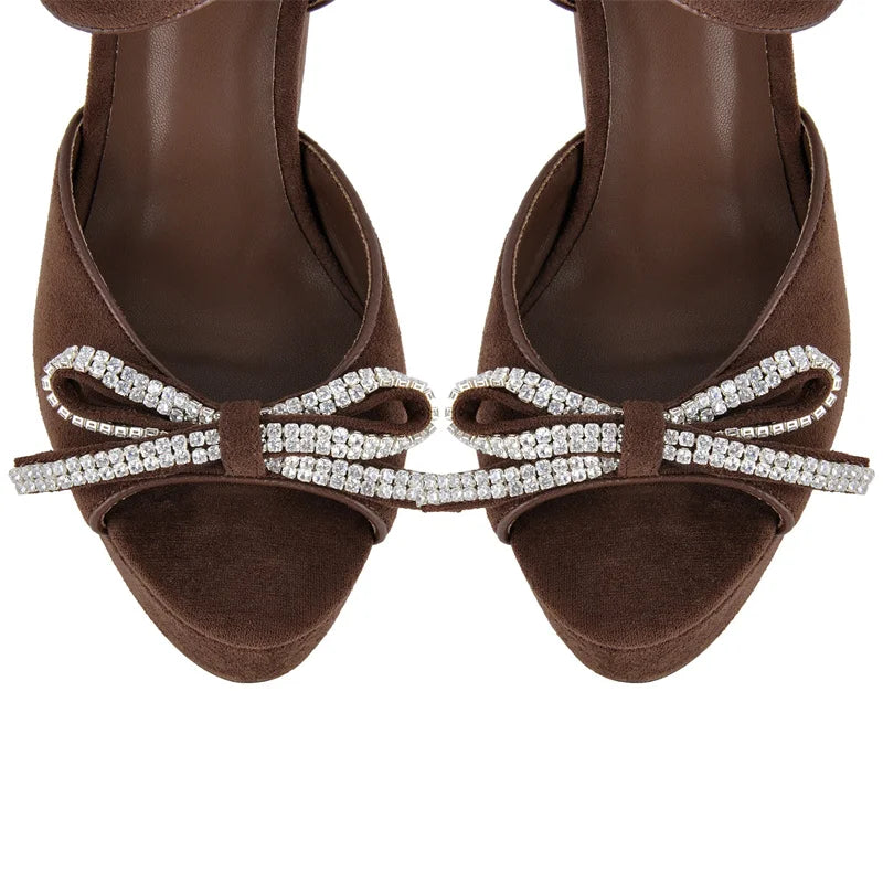Top view of brown faux suede platform sandals with rhinestone bow details
