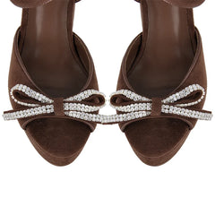 Top view of brown faux suede platform sandals with rhinestone bow details