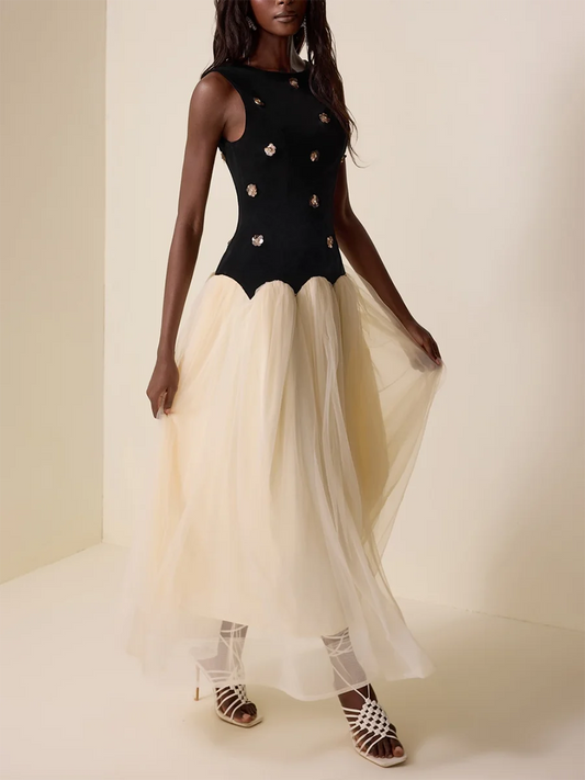 Woman wearing a black bodice with gold embellishments and a beige skirt on a plain background
