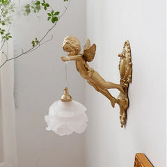 A luxurious crystal wall lamp with a French bronze angel design, casting a warm glow in a living room .Golden Atelier  4