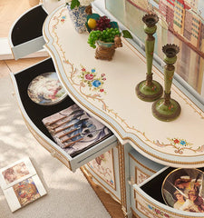 Decorative console table with storage drawers and decorative items on a light-colored surface.