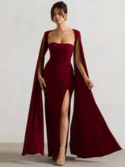 Model wearing a flowing cape sleeve maxi dress with a high split. 3