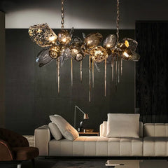 Modern living room with a stylish chandelier, gray sofa, and dark wall.