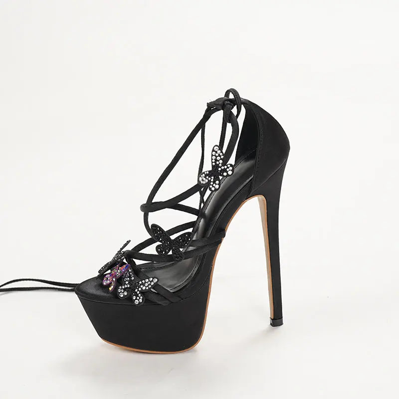 Black high-heeled sandal with decorative elements 