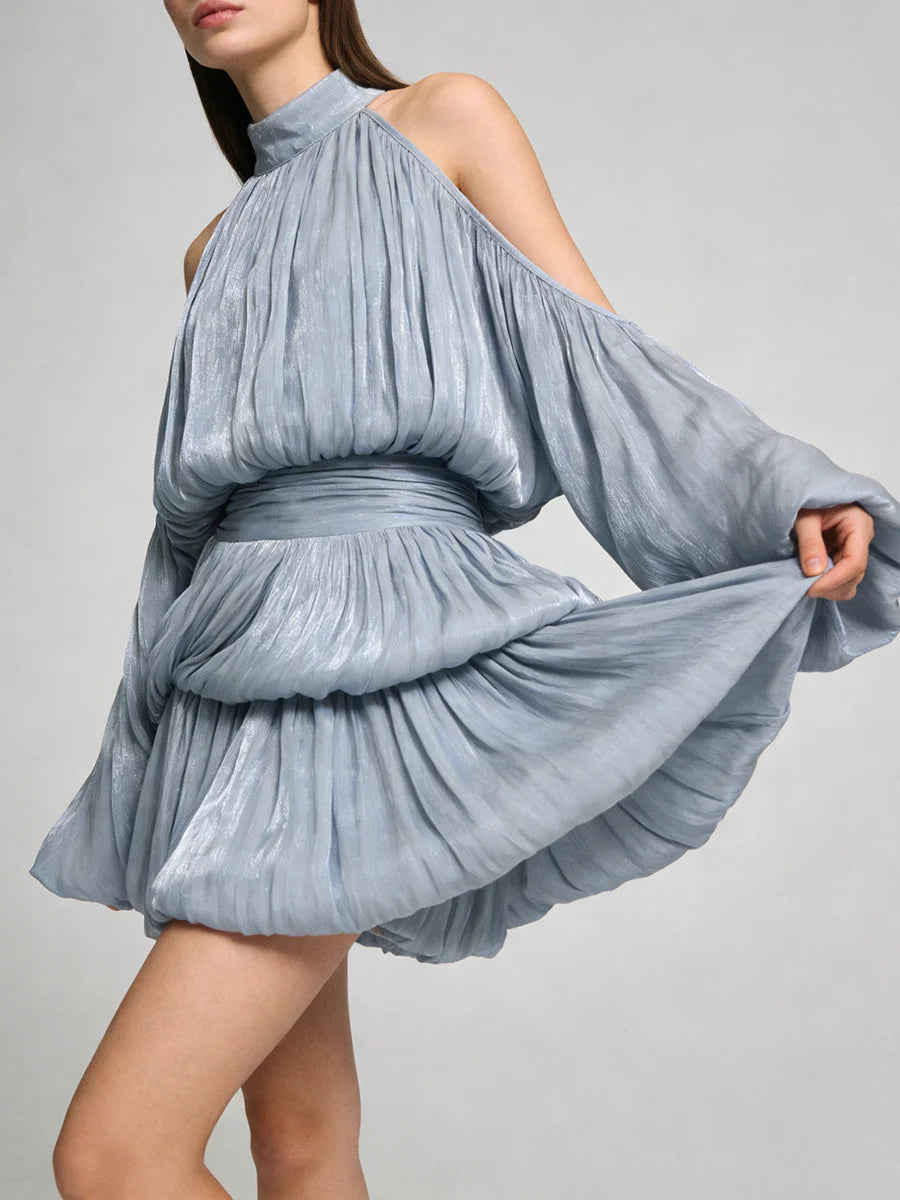 Blue pleated dress with long sleeves on a gray background