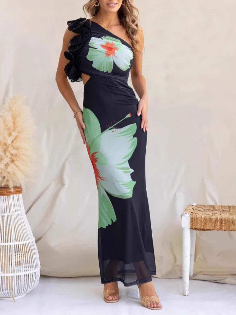 Woman wearing a black one-shoulder dress with floral designs against a white background