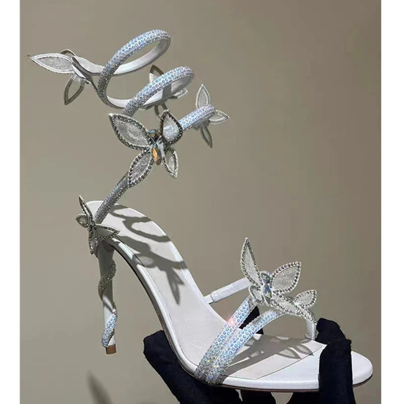 White high-heeled shoe with butterfly embellishments