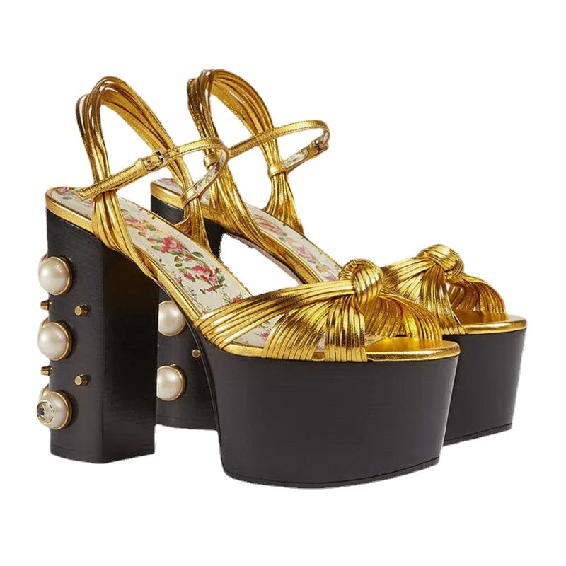 Pair of gold metallic platform sandals with a chunky block heel and rivet detail.