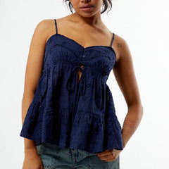 Woman wearing a navy blue patterned top on a white background